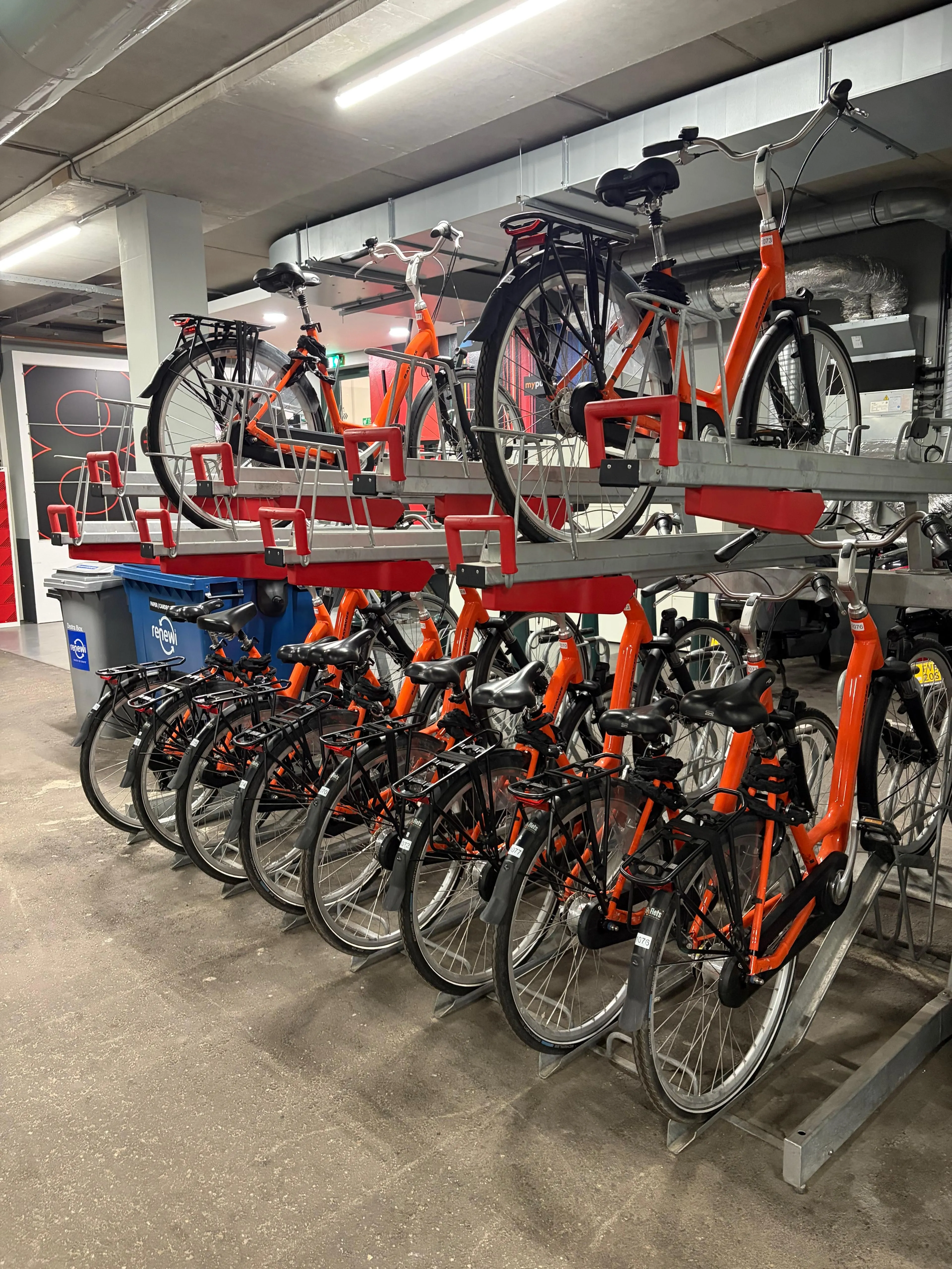 Employees on shared bikes setting off from an office in Amsterdam